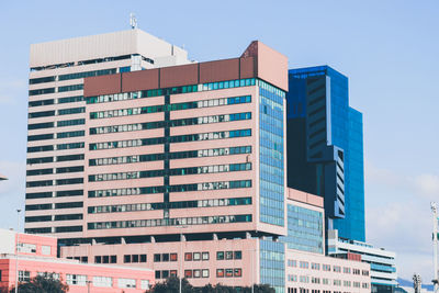 Low angle view of modern buildings against sky