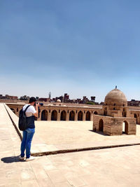Man taking pictures of the architecture of historic mosque 