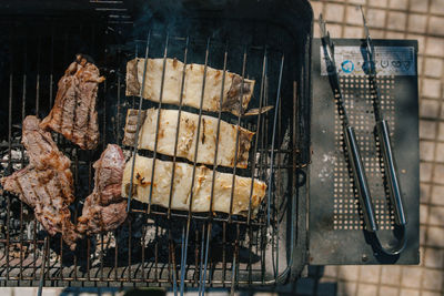 High angle view of meat on barbecue grill