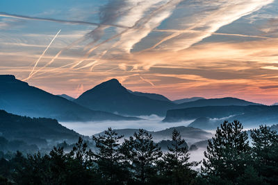 Scenic view of mountains against sky at sunset