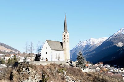 Panoramic view of cathedral and mountains against clear sky