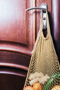 Close-up of clothes hanging on metal door