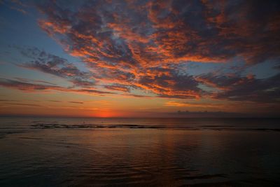 Scenic view of sea against romantic sky at sunset