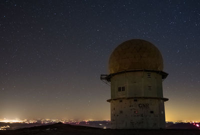 Built structure against starry sky at night