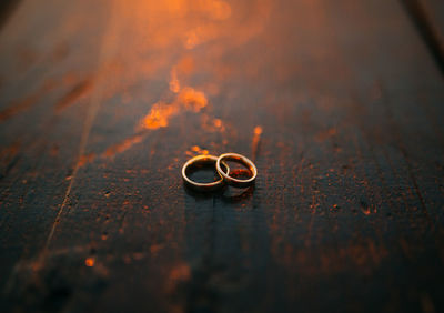 Close-up of wedding rings on table