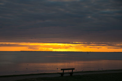 View of calm beach at sunset