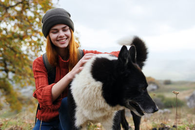 Portrait of smiling young woman in park during winter