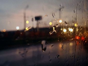 Close-up of raindrops on car window during rainy season