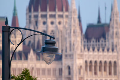 Street light against building in city