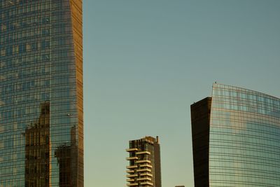 Low angle view of modern buildings against clear sky