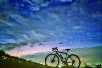 Bicycle against sky at sunset