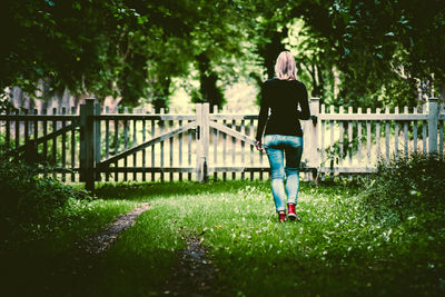 Full length of woman walking on bridge