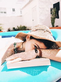 Portrait of woman relaxing in swimming pool