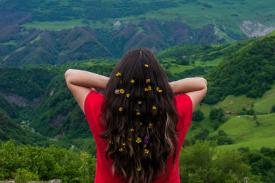 Rear view of woman wearing hat on mountain