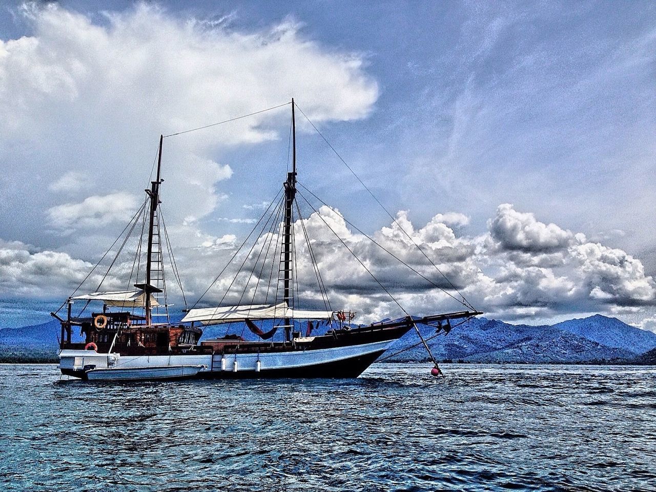 water, nautical vessel, sea, sky, boat, transportation, waterfront, mode of transport, cloud - sky, tranquil scene, tranquility, sailboat, scenics, beauty in nature, cloudy, mast, cloud, nature, sailing, rippled