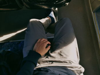 Low section of man sitting in bus