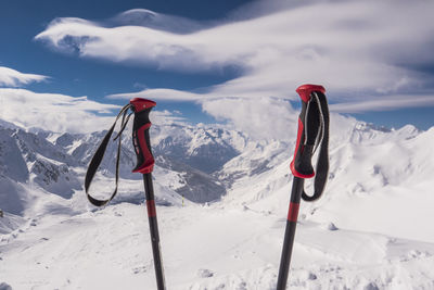 Person standing on snow covered mountain against sky