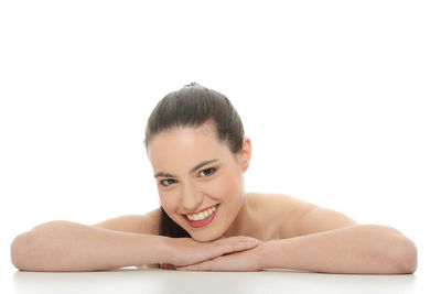 Portrait of a smiling young woman over white background