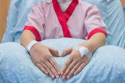 Midsection of patient on hospital bed