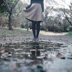 Rear view of woman standing on grass