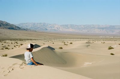 Full length of man on arid landscape against sky