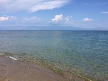 Scenic view of beach against blue sky