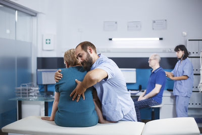 Side view of female friends sitting at home