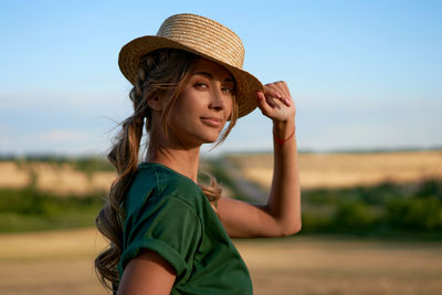 Portrait of woman wearing hat against sky