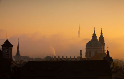 Buildings against sky during sunset