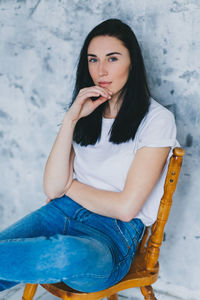 Portrait of beautiful young woman sitting outdoors