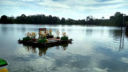 Boat in lake against sky