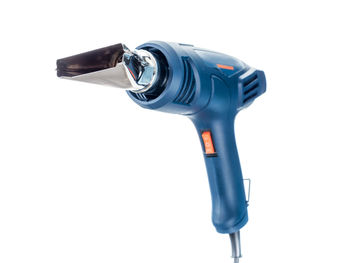 Close-up of hair dryer against white background