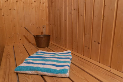 Close-up of bucket and towel at sauna