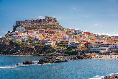 Townscape by sea against sky in city