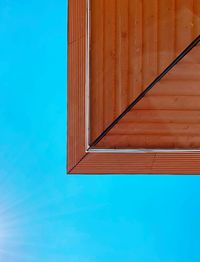 Directly below shot of swimming pool against clear blue sky