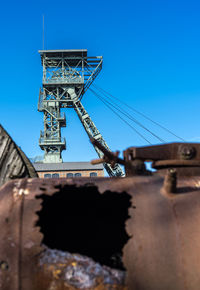 Low angle view of construction site against clear blue sky