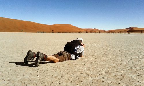 Rear view of man lying on mountain