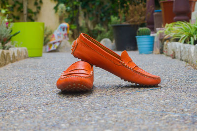 Close-up of leather shoes on footpath