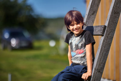 Portrait of boy looking away while standing outdoors