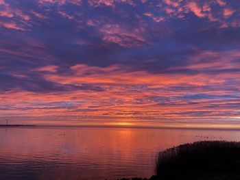 Scenic view of sea against romantic sky at sunset