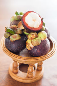 Close-up of mangosteens in eggcup on table