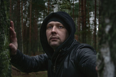 Portrait of young man in forest