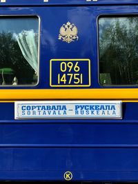 Close-up of yellow sign on car windshield