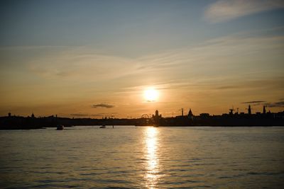 Scenic view of river against sky during sunset