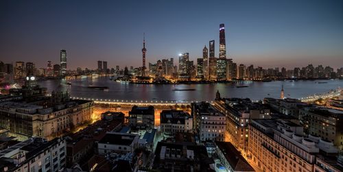Aerial view of city lit up at night