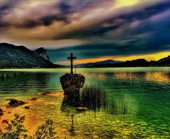 Scenic view of lake against cloudy sky