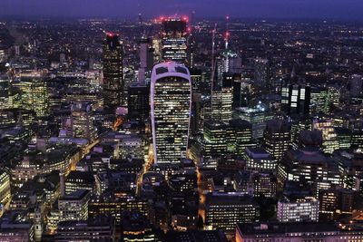 High angle view of city lit up at night