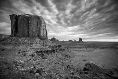 Rock formation at desert against storm clouds