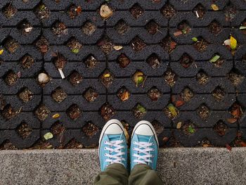 Low section of man standing on footpath