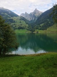 Scenic view of lake and mountains against sky